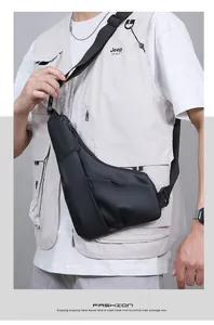 Close-up of minimalist black men's chest bag with matte finish and waterproof texture