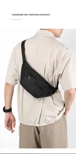 Rear view of a black nylon crossbody bag with adjustable strap worn by a male model