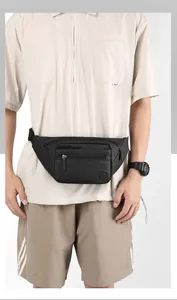 Detail of black nylon waist bag showing fashion logo, zipper pockets and adjustable buckle