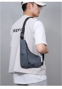Close-up of slim grey-blue chest bag featuring waterproof matte texture and large plastic buckle