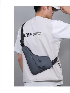 Close-up of slim anti-theft chest bag with waterproof matte texture on male model