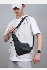 Close-up of minimalist black men's chest bag showing matte waterproof texture and zip