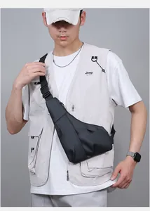 Men's slim black crossbody chest bag with water-resistant matte texture on model
