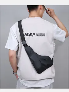 Rear view of a men's matte black triangle sling bag featuring adjustable nylon straps