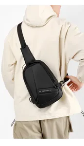 Detail view of a black oxford fabric crossbody bag on a model showing modern street style