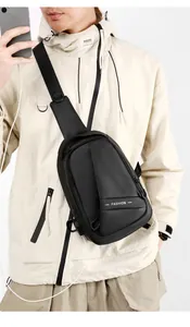 Detailed view of the black men's chest bag featuring fashion webbing and oxford fabric