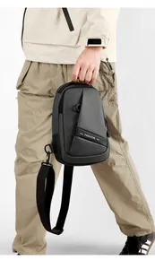 Detail of dark grey waterproof oxford chest bag featuring a fashion strap and sleek zipper