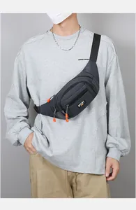 Detail of gray sports waist bag featuring multi-pocket design and orange zipper pulls