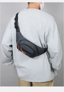 Detail of dark grey sports waist bag with multiple zippers and orange pull cords