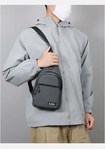 Detail of dark grey oxford fabric chest bag with S SPORT label and earphone port