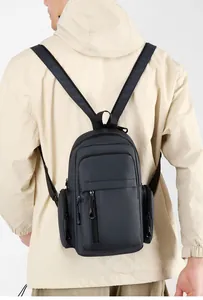 Rear view of model wearing a grey multi-pocket waterproof nylon crossbody bag