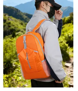 Outdoor foldable backpack in bright orange with side mesh pocket and gray strap details
