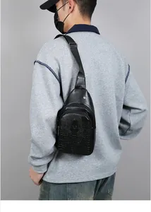 Detail view of the black crocodile pattern texture and dual zippers on the men chest bag