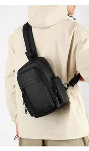 Detail of adjustable padded shoulder strap on a black nylon crossbody bag for men
