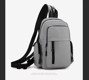 Detail view of light grey multi-functional chest bag showing storage compartments