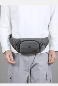 Detailed view of a multi-layer gray nylon waist bag with waterproof zippers and fashion label