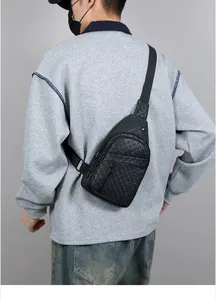 Detail of man wearing black leather chest bag with embossed stars and adjustable strap