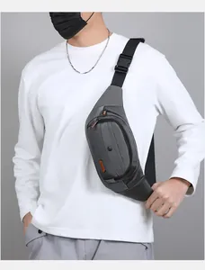 Detail of gray waterproof nylon waist bag showing front zipper pocket and adjustable strap