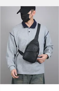Detail of black crossbody bag with embossed star patterns and adjustable strap texture