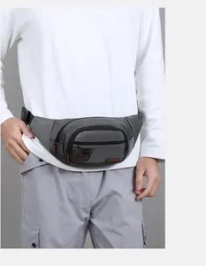 Close-up of a men's waterproof waist bag with multiple zipper pockets and metal D-ring