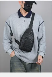 Detailed view of black sling bag with embossed star texture and adjustable shoulder strap