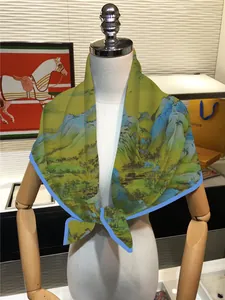 Detail of Chinese landscape painting silk scarf with blue borders on a mannequin bust