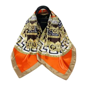 Detail of 90cm satin square scarf with baroque patterns draped over a black handbag