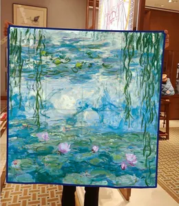 Detail of Monet silk scarf featuring Water Lilies oil painting print held open in hand