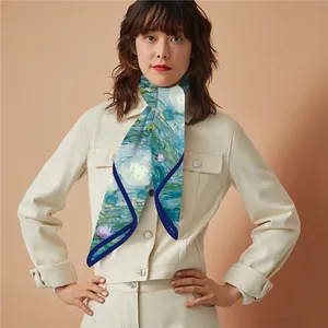 Detail of Monet water lily oil painting style silk scarf paired with cream denim jacket