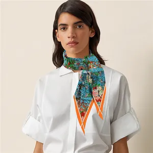 Detail of silk skinny scarf featuring garden botanical patterns and orange borders