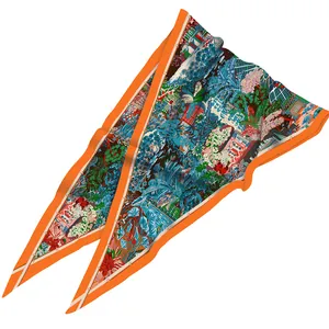 Detailed close-up of a diamond-shaped silk scarf featuring vibrant botanical garden prints