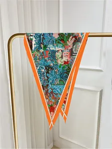 Detail of colorful tropical flora print on silk scarf with vibrant orange border
