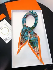 Detailed macro view of the floral garden print silk scarf with orange border