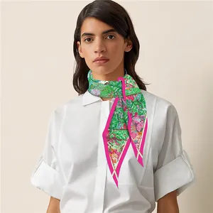 Detail of colorful floral silk twilly scarf styled on a white shirt collar