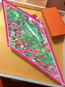 Detail of French garden print silk scarf with floral patterns and orange gift box