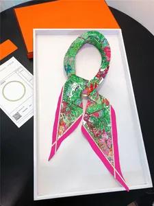 Detail of French floral diamond-shaped silk scarf in premium orange gift box packaging