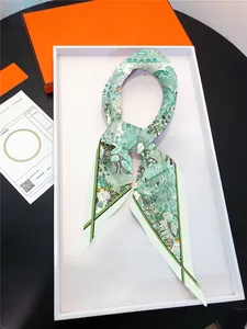Detailed view of floral diamond silk scarf elegantly displayed in a luxury orange gift box