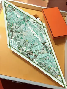 Detail of diamond silk scarf with garden prints and luxury orange gift box