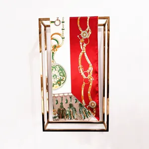 Detailed view of 90cm silk scarf with vintage gold chain buckle and tassel patterns
