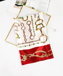 Detailed texture of 90cm silk scarf with gold chain and horsebit equestrian pattern