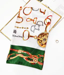 Detail of silk scarf with equestrian chain print and floral medallion on a gold frame