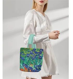 Detail of Van Gogh Irises painting print on a stylish tote bag with green handles