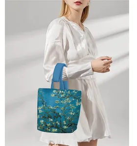 Close-up of Van Gogh Almond Blossom print handbag with wide straps in turquoise finish