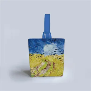 Detail of Van Gogh Wheatfield under Thunderclouds print on a canvas tote with blue handles