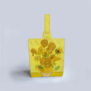Detail of yellow canvas tote bag featuring Van Gogh Sunflowers art print and matching handles