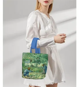 Detail view of canvas tote bag featuring Van Gogh artwork with blue handles