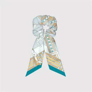 Detail of silk-like twill hair scrunchie with equestrian pattern and long streamers