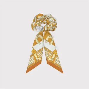 Elegant equestrian style silk scarf scrunchie featuring horse bit and belt patterns