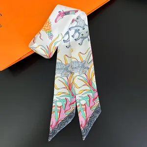 Detailed macro view of twilly scarf with elephant and giraffe animal floral prints