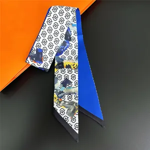 Detail of royal blue twilly silk scarf with letter print and vibrant oil painting patterns